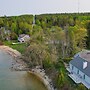 Lakefront De Tour Village Home w/ Deck & Fire Pit!