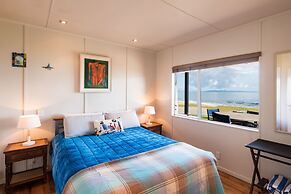 Cable Bay Stays – Golden Sand and Driftwood Beachfront Accommodation