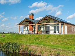 Bungalow With an Outdoor Fireplace by Water