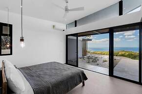 Luxurious Ultramodern Property with Private Suites, Infinity Pool, and
