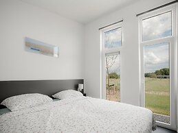 Nice Chalet with Fireplace near Oosterschelde