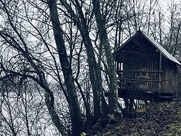 Tiny hut in the Forest Overlooking the River